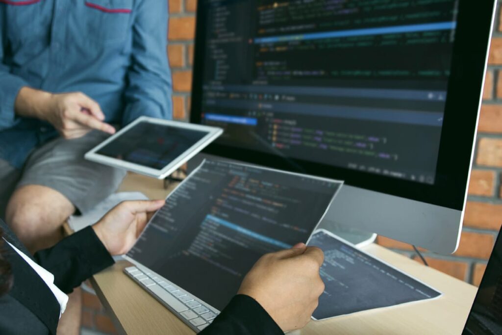 Young woman sitting in a yellow chair on her laptop