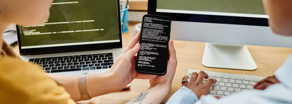 Colleagues writing security codes in team