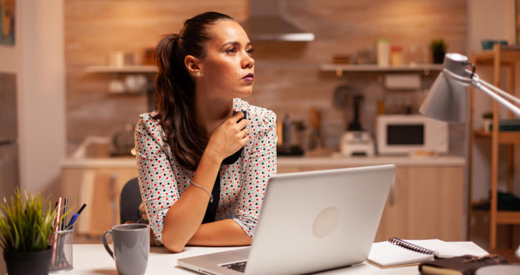 Person uses laptop within small apartment